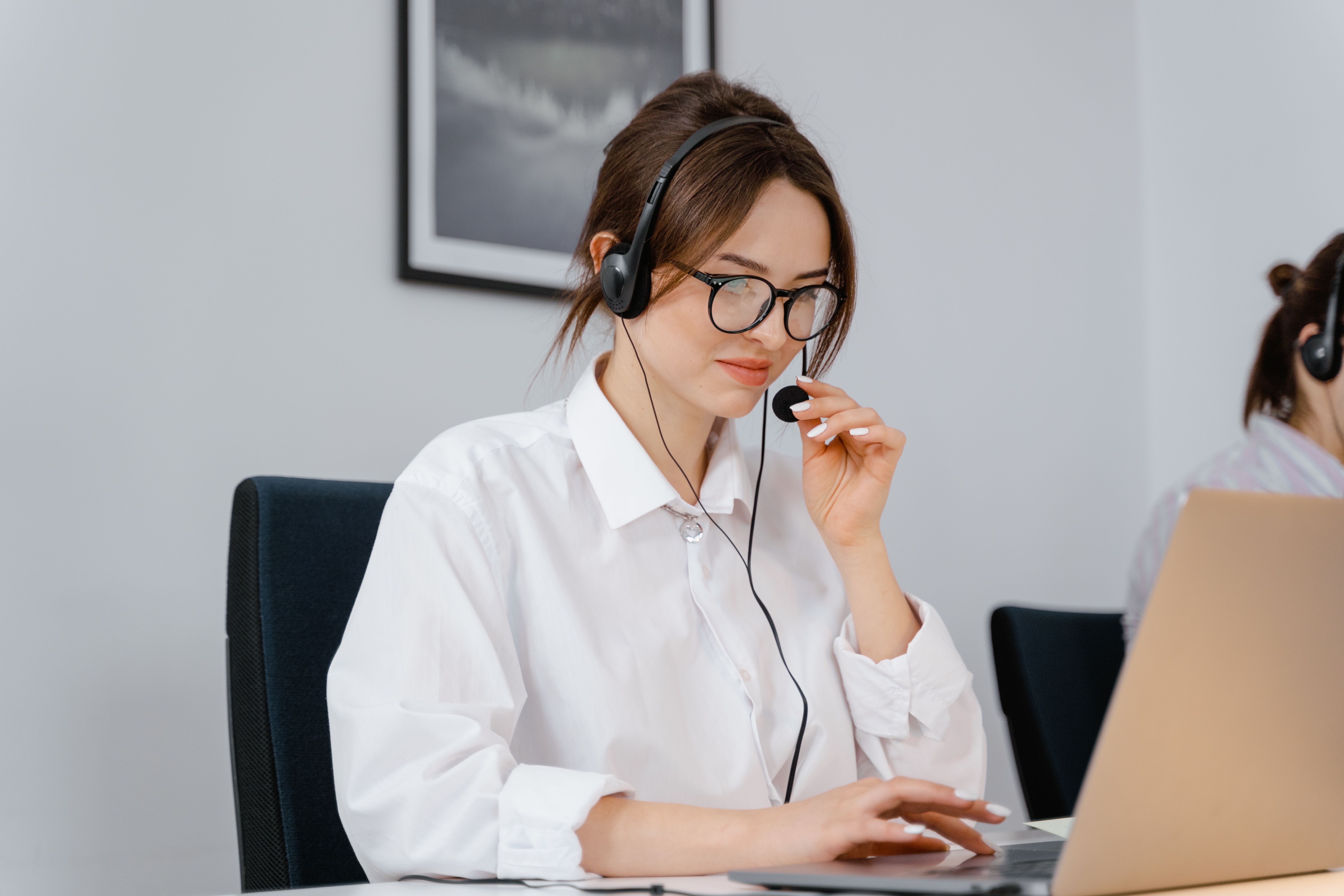 WebWave support specialist wearing a headset at a laptop