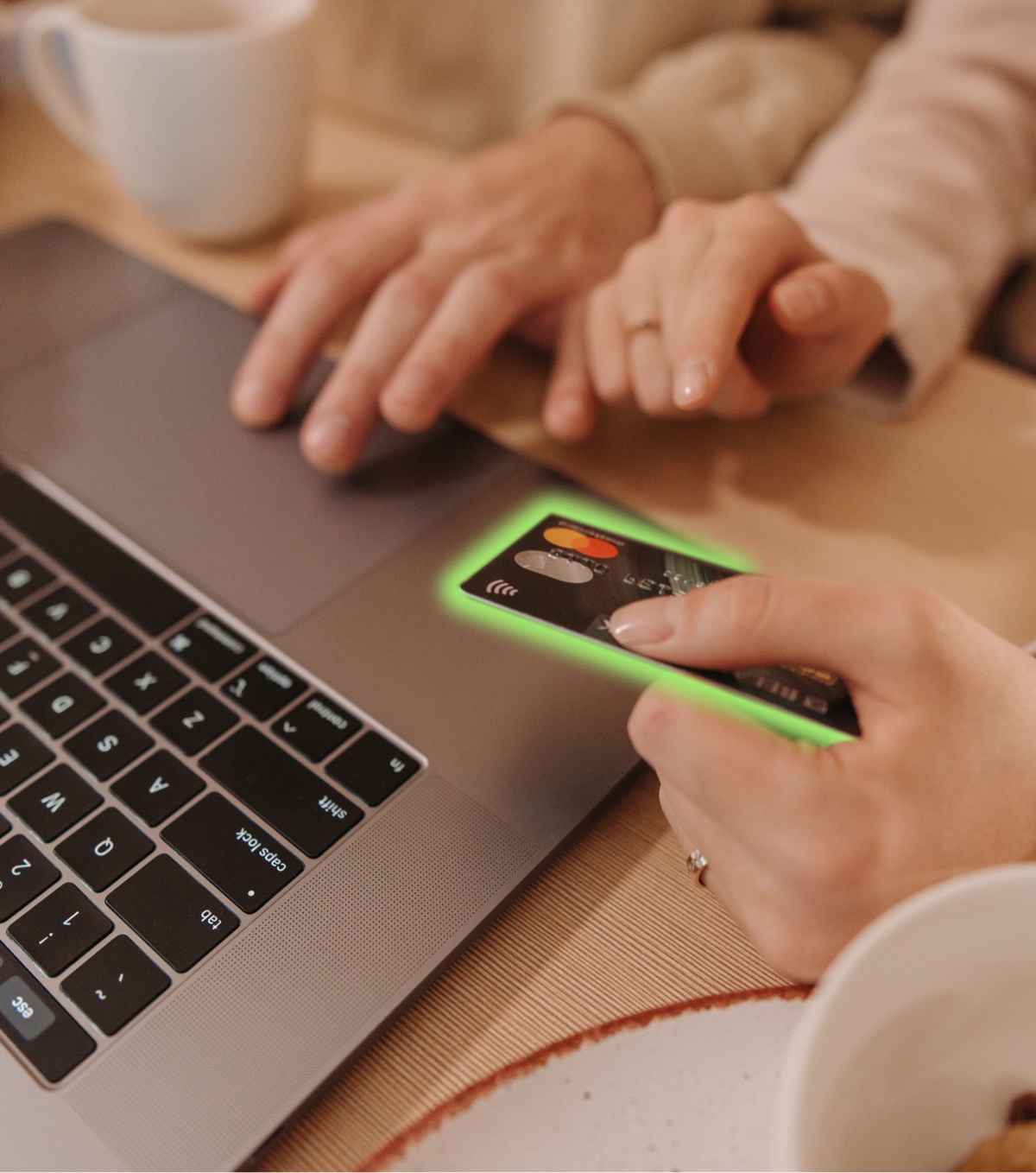Online shopping — paying by contactless card next to a laptop